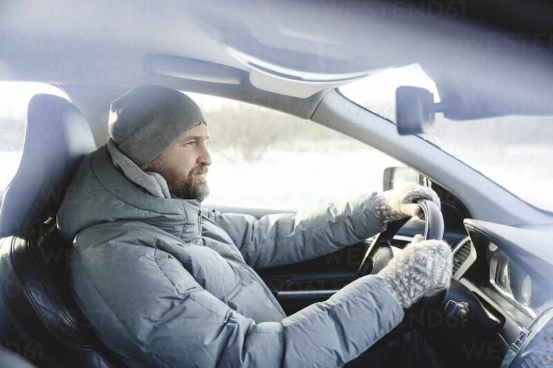 driver with thick coat behind the wheel